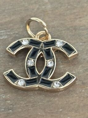 CHANEL gold tone pendant zipper pull, black enamel and gold tone.